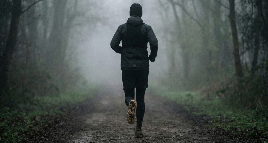 Runner in foggy forest