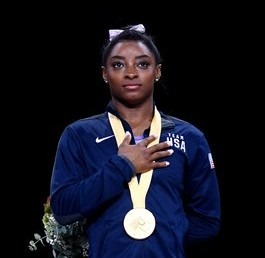 Simone Biles with Olympic medal
